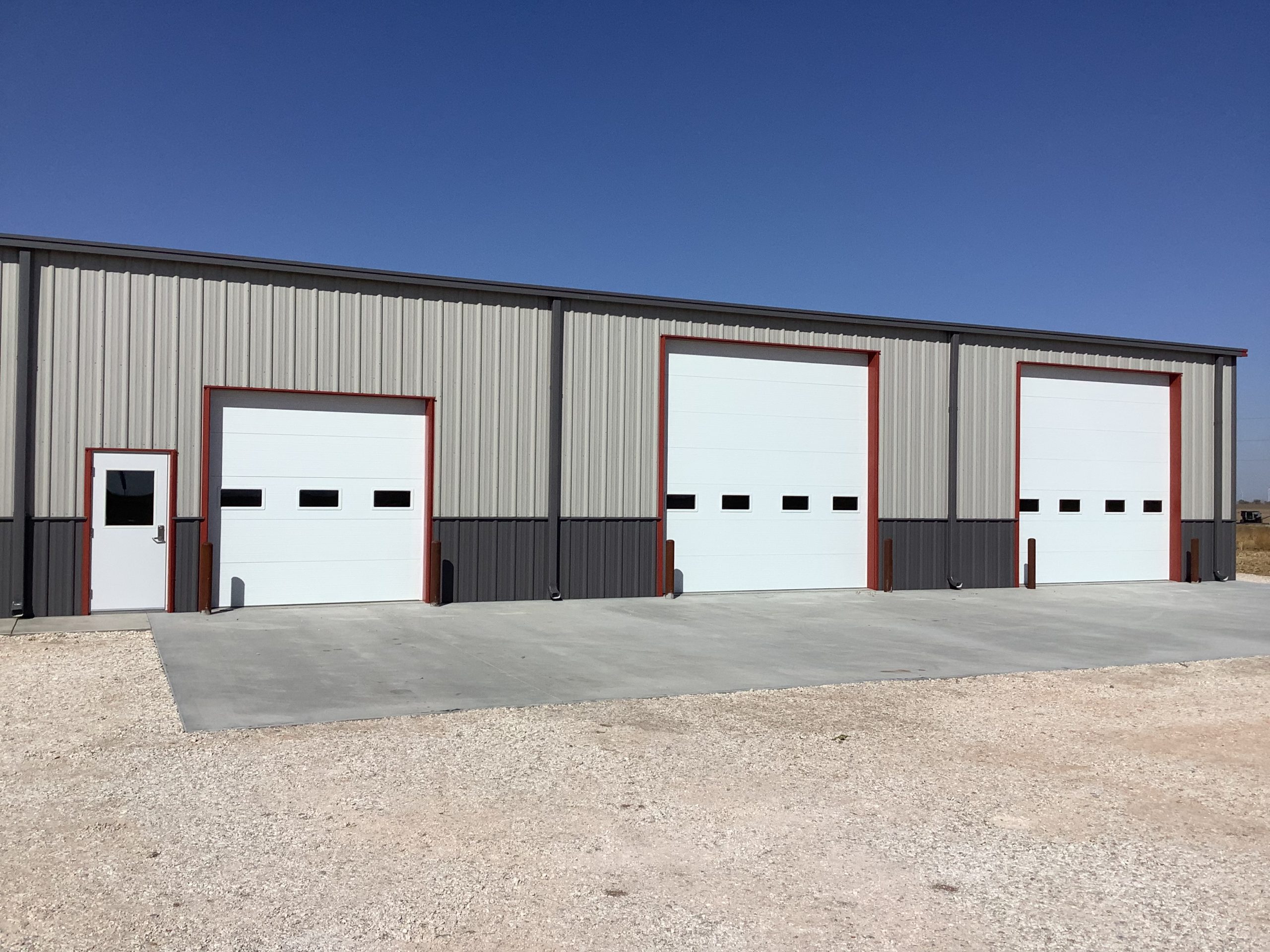 Outdoor view of insulated commercial doors in various sizes